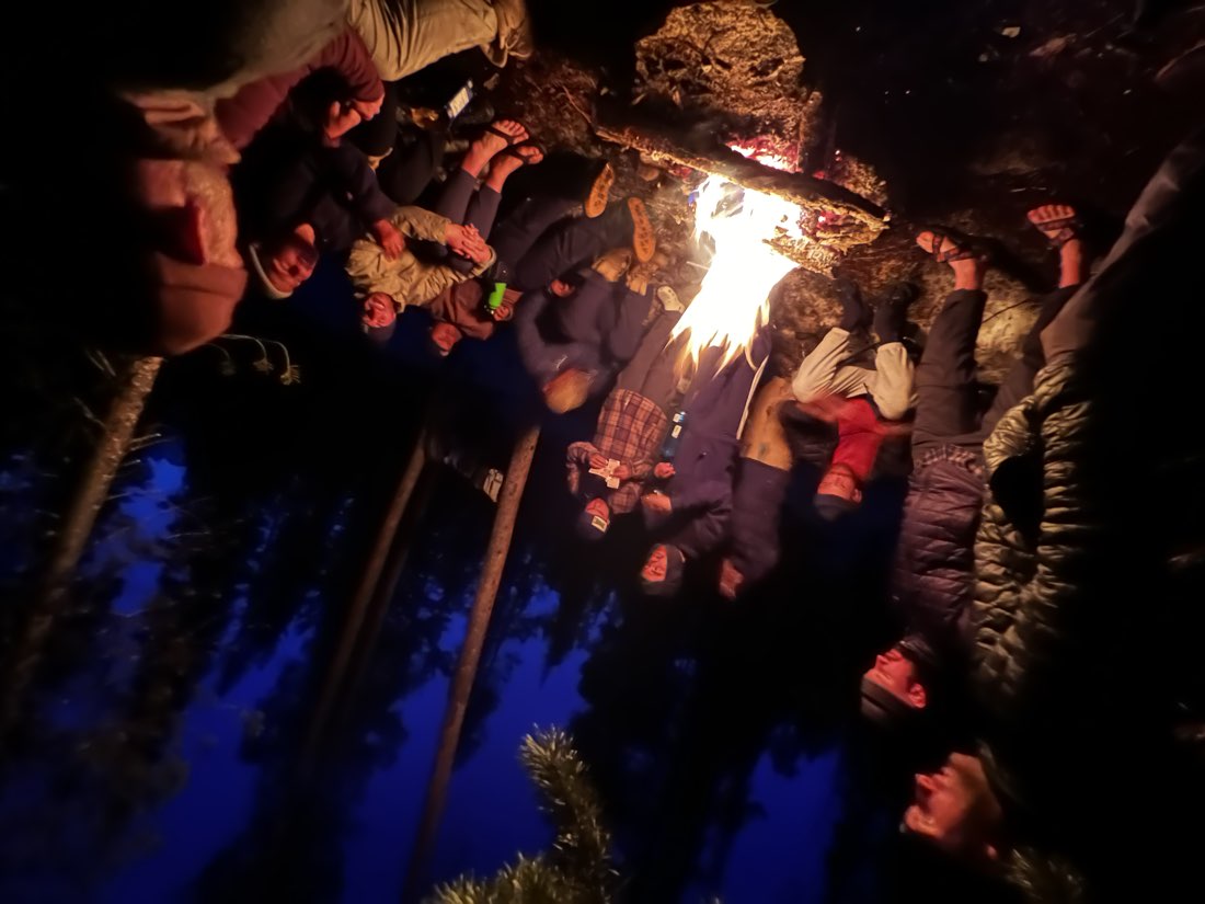 Friends around a campfire at night