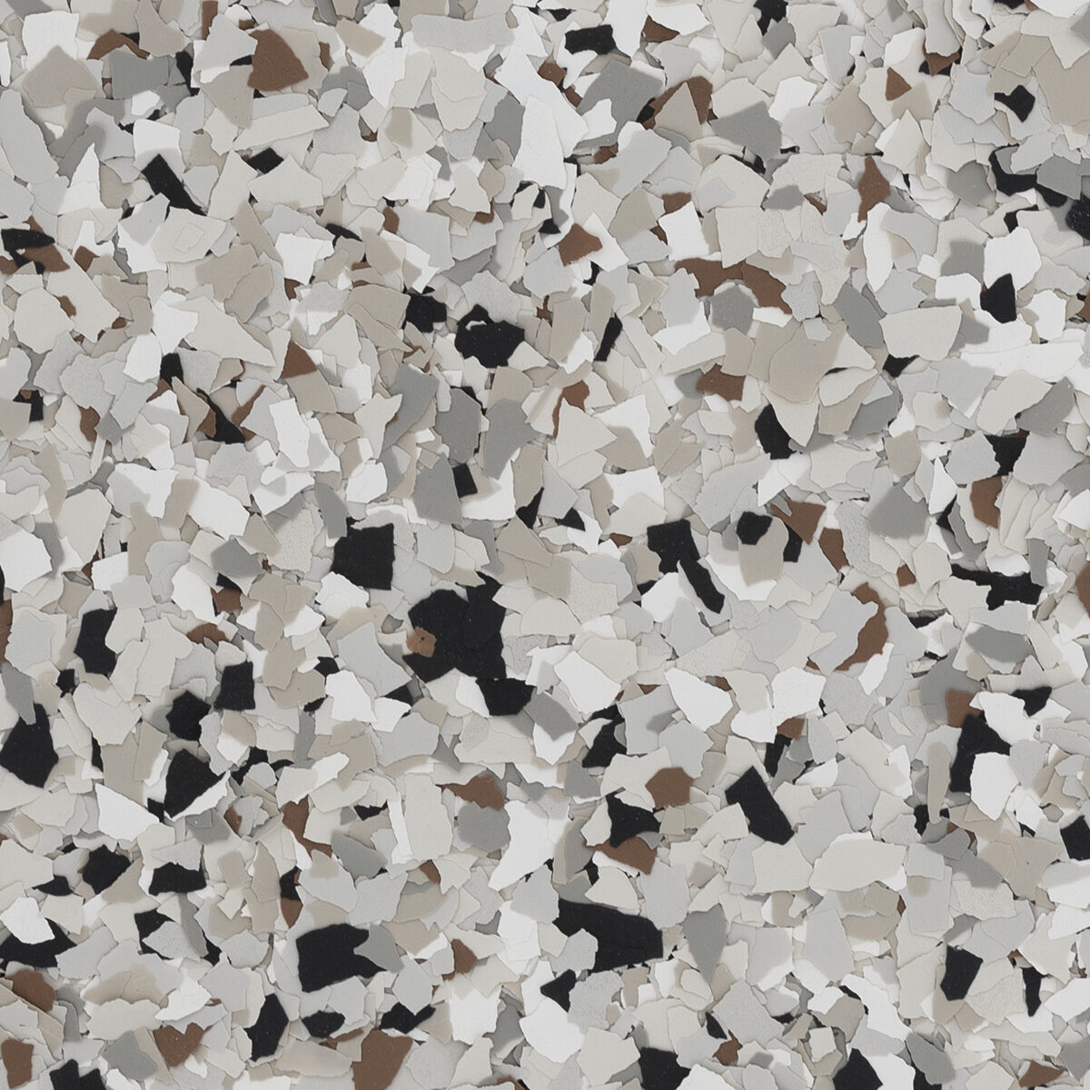 Coyote flake blend spread across a floor: warm gray, white, black and brown
