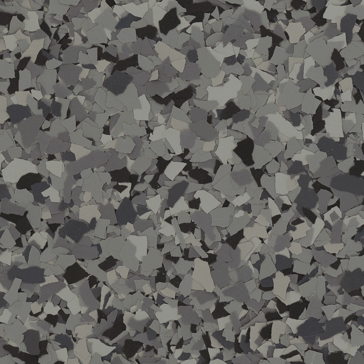 Nightfall flake blend spread across a floor: dark gray and black