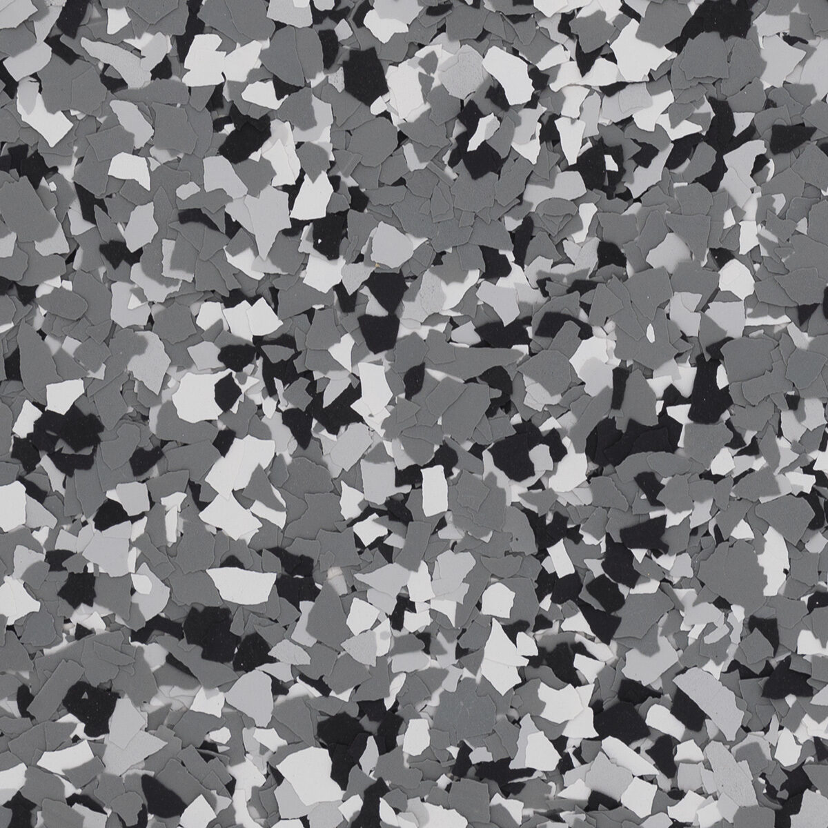 Wombat flake blend spread across a floor: medium gray with black and white