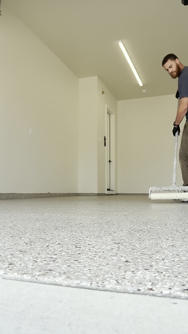 Rolling topcoat across a finished flake floor