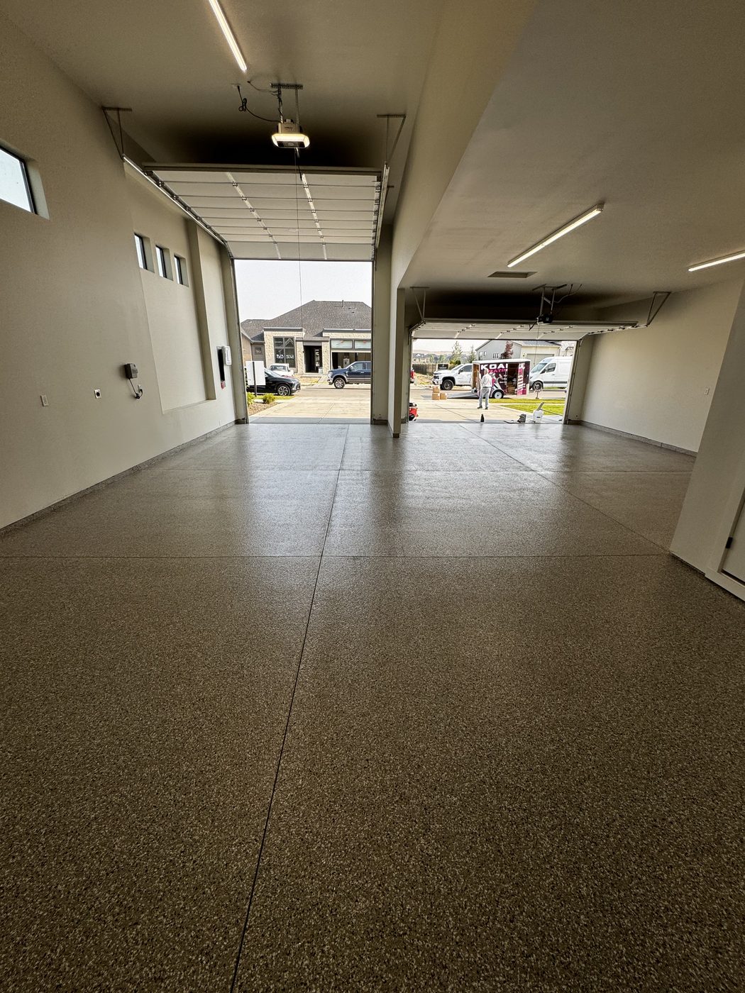 Finished flake garage floor with the bay doors open